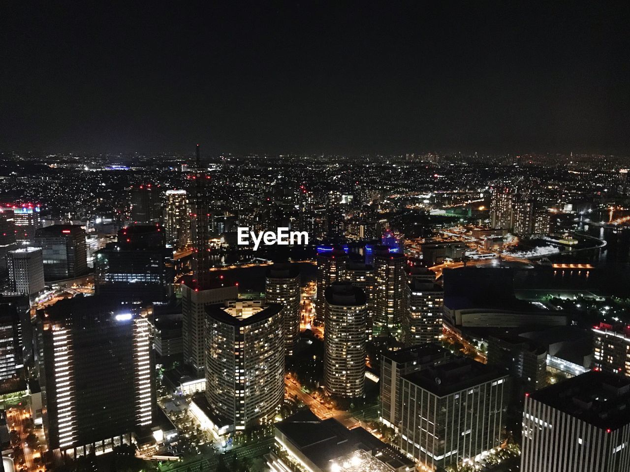 High angle view of illuminated cityscape against sky at night