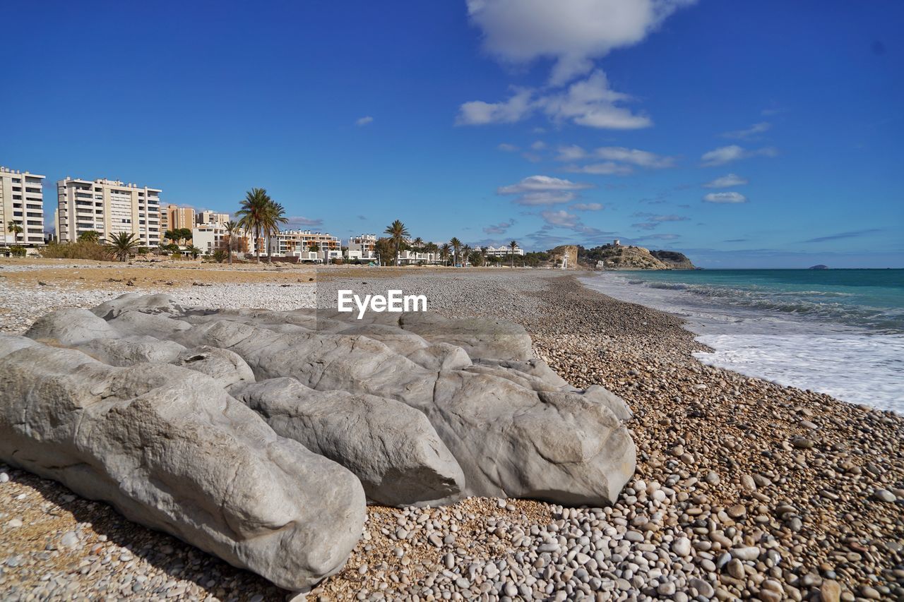 sea, water, beach, land, sky, shore, coast, rock, ocean, sand, nature, travel destinations, body of water, architecture, blue, vacation, beauty in nature, scenics - nature, travel, cloud, coastline, horizon, no people, tourism, terrain, holiday, wave, built structure, outdoors, environment, water's edge, day, trip, tranquility, landscape, horizon over water, building exterior, tropical climate, tranquil scene