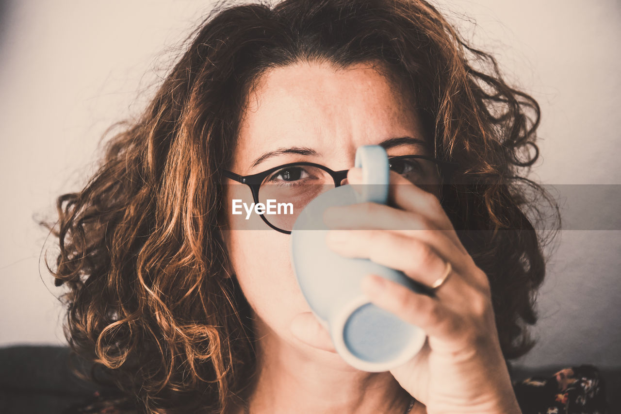 Portrait of woman drinking coffee in cup