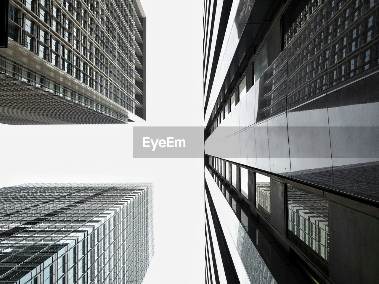 Directly below shot of modern buildings against clear sky