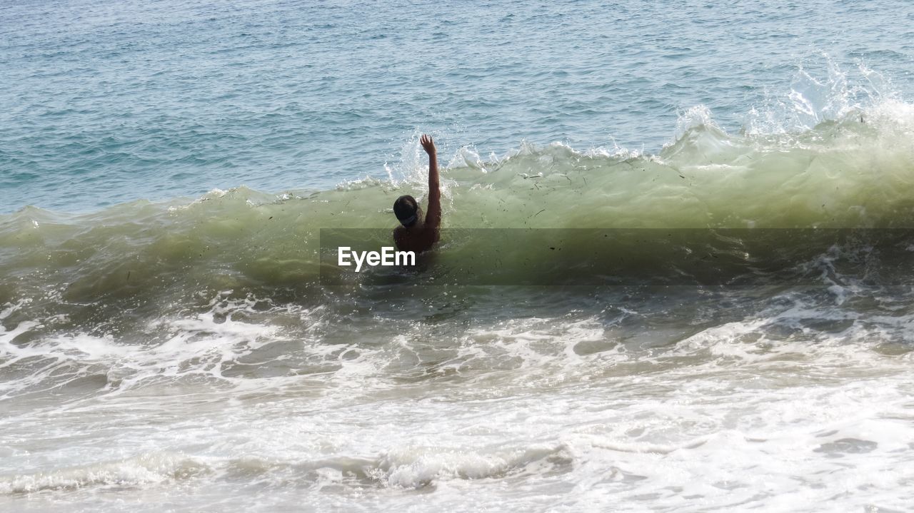 High angle view of boy swimming in sea