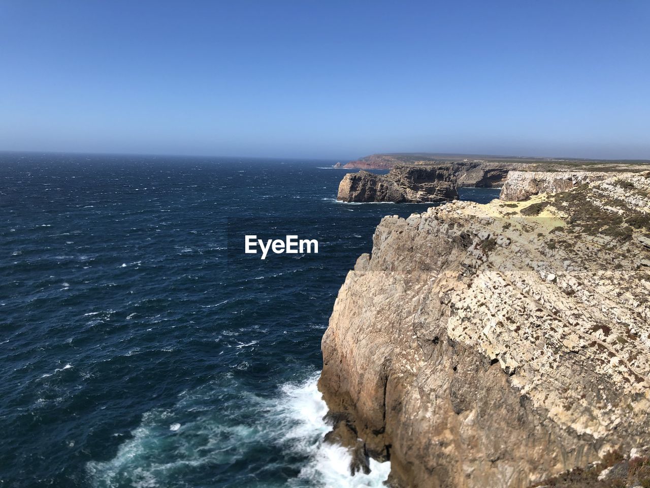ROCK FORMATION IN SEA AGAINST SKY