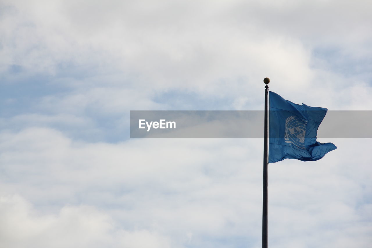 United nations flag waving against sky