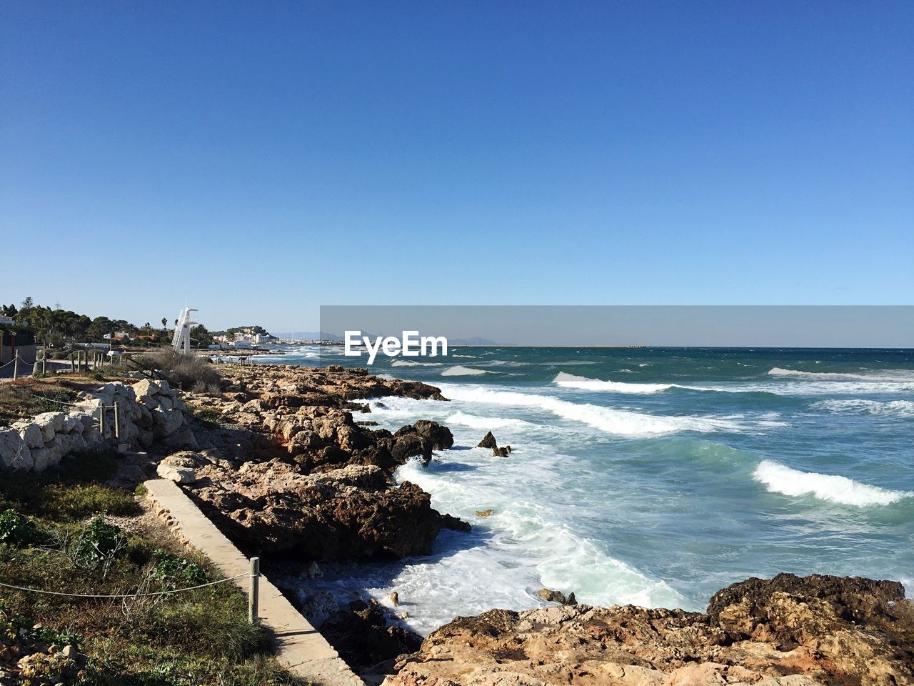 Scenic view of sea against clear blue sky