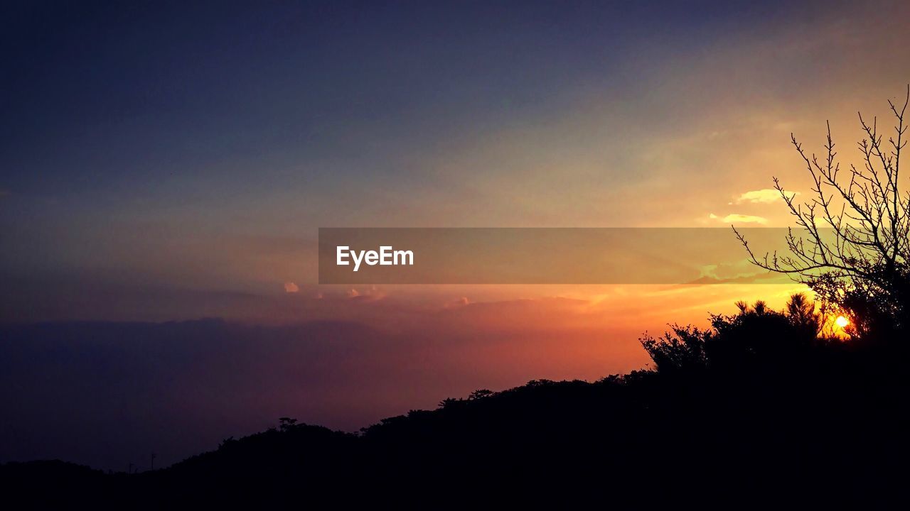 Silhouette landscape against scenic sky