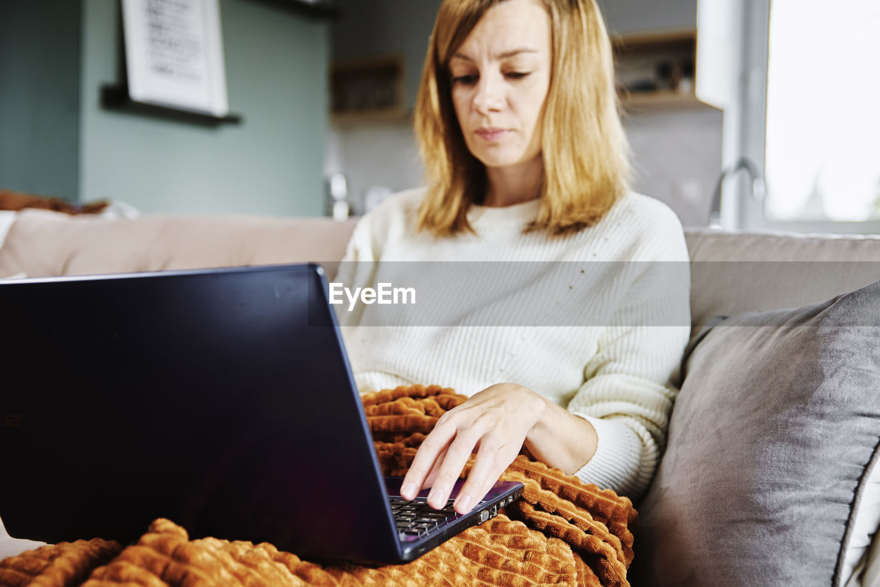 Woman working at home with laptop