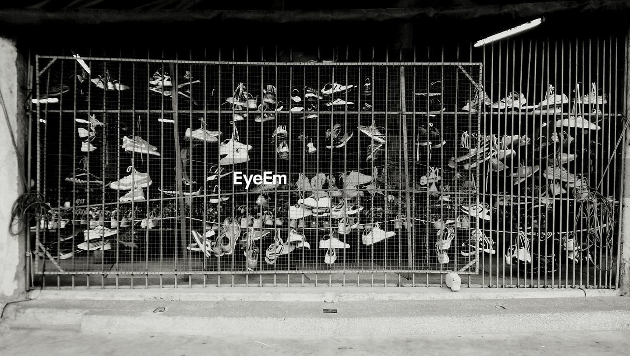 Shoes on metal gate