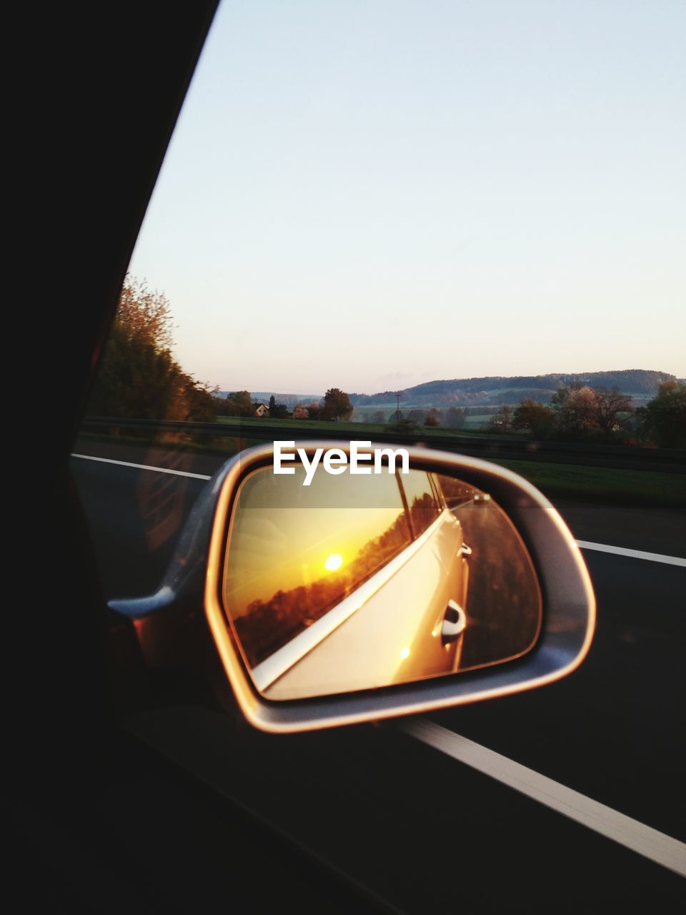 Reflection of car in rear view mirror