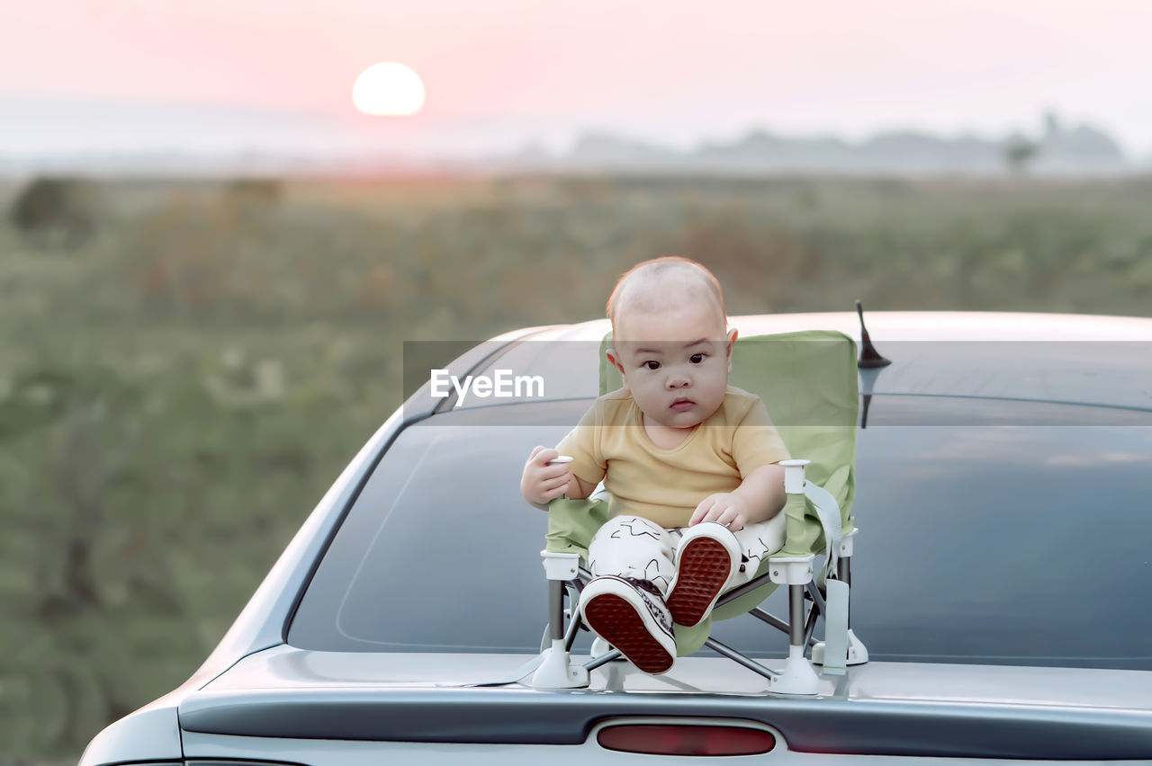 Portrait of boy playing with toy car