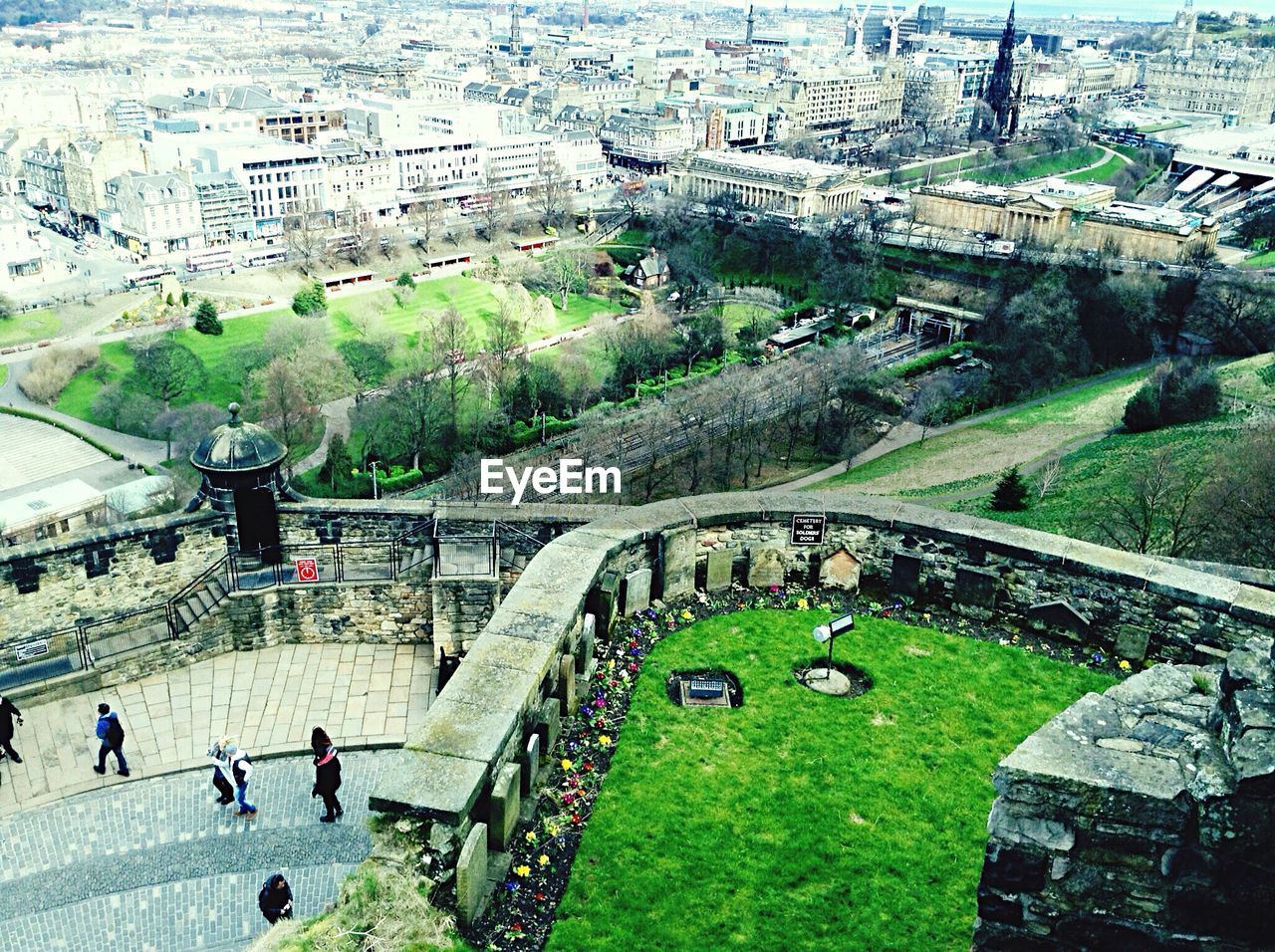 High angle view of people standing in castle against city