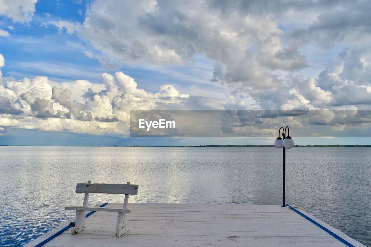 White old wood pontoon with one bench and light