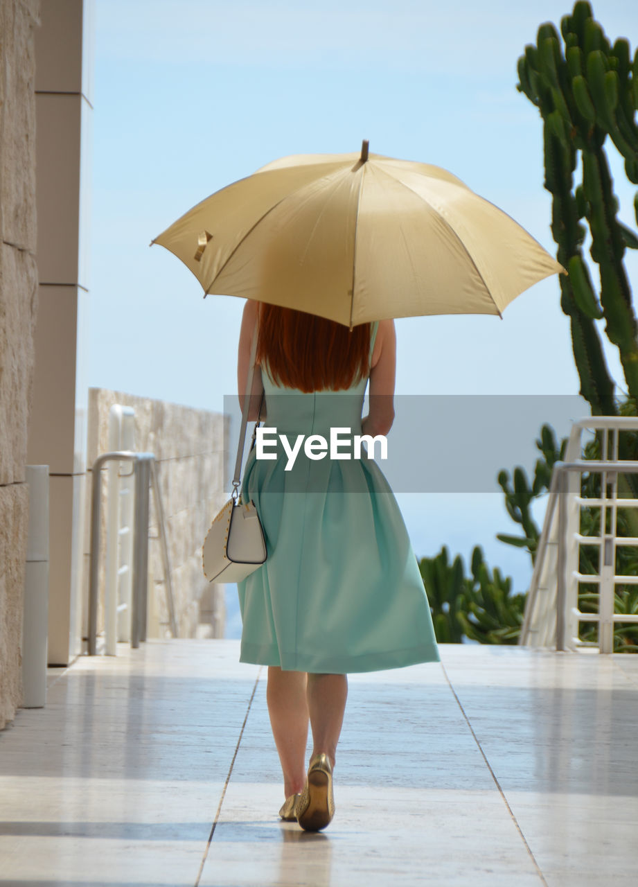 Rear view of woman with umbrella