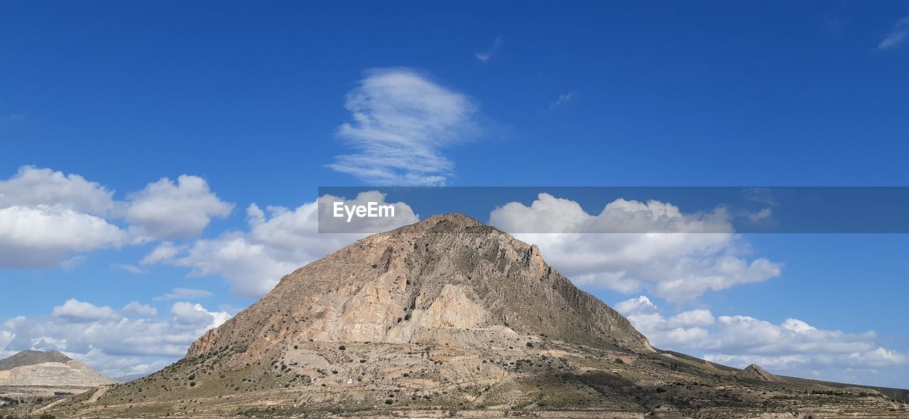 Low angle view of rocky mountain against sky