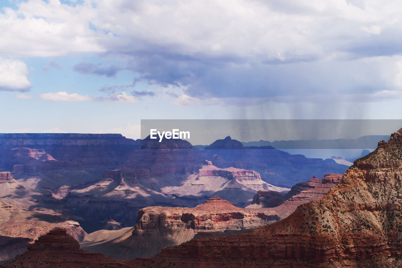 Scenic view of rocky mountains against cloudy sky at grand canyon national park