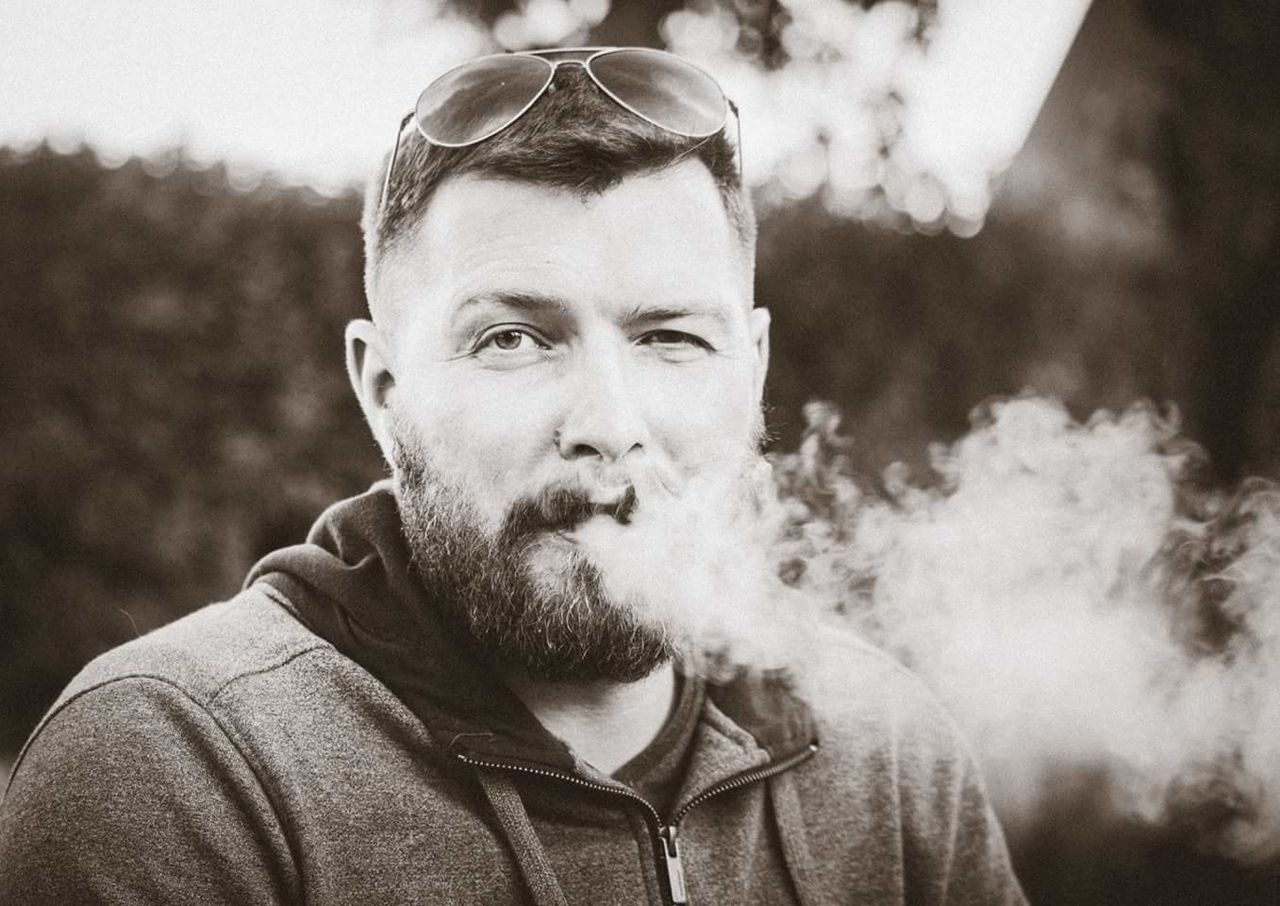 Portrait of man smoking outdoors