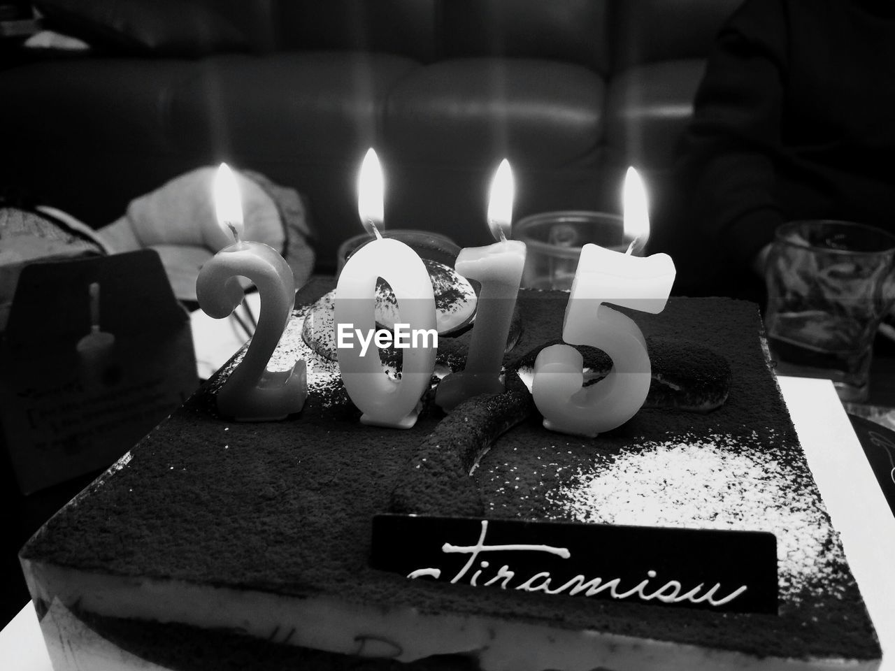 Close-up of illuminated number candles on cake