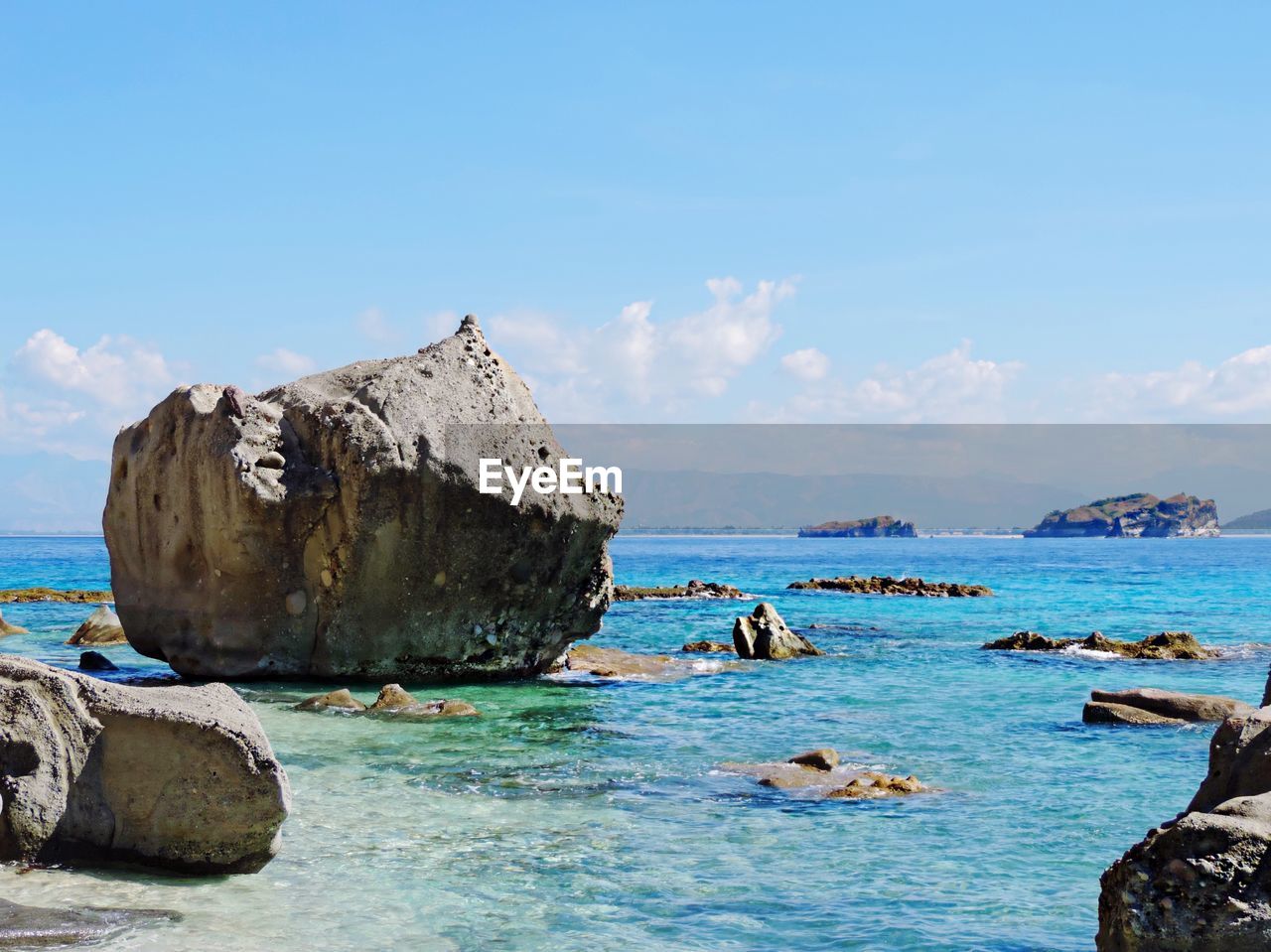 Rock formations in sea against sky