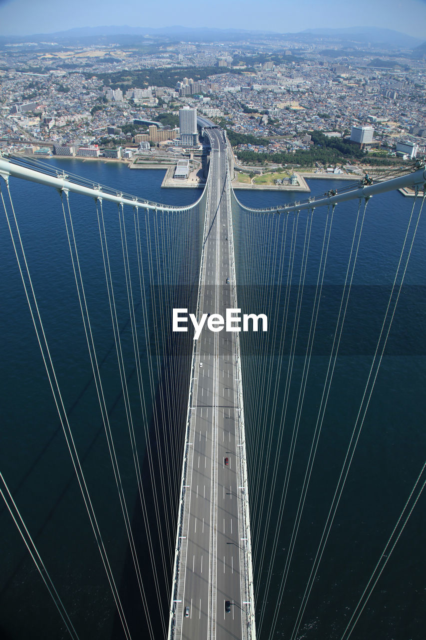 High angle view of suspension bridge and buildings in city