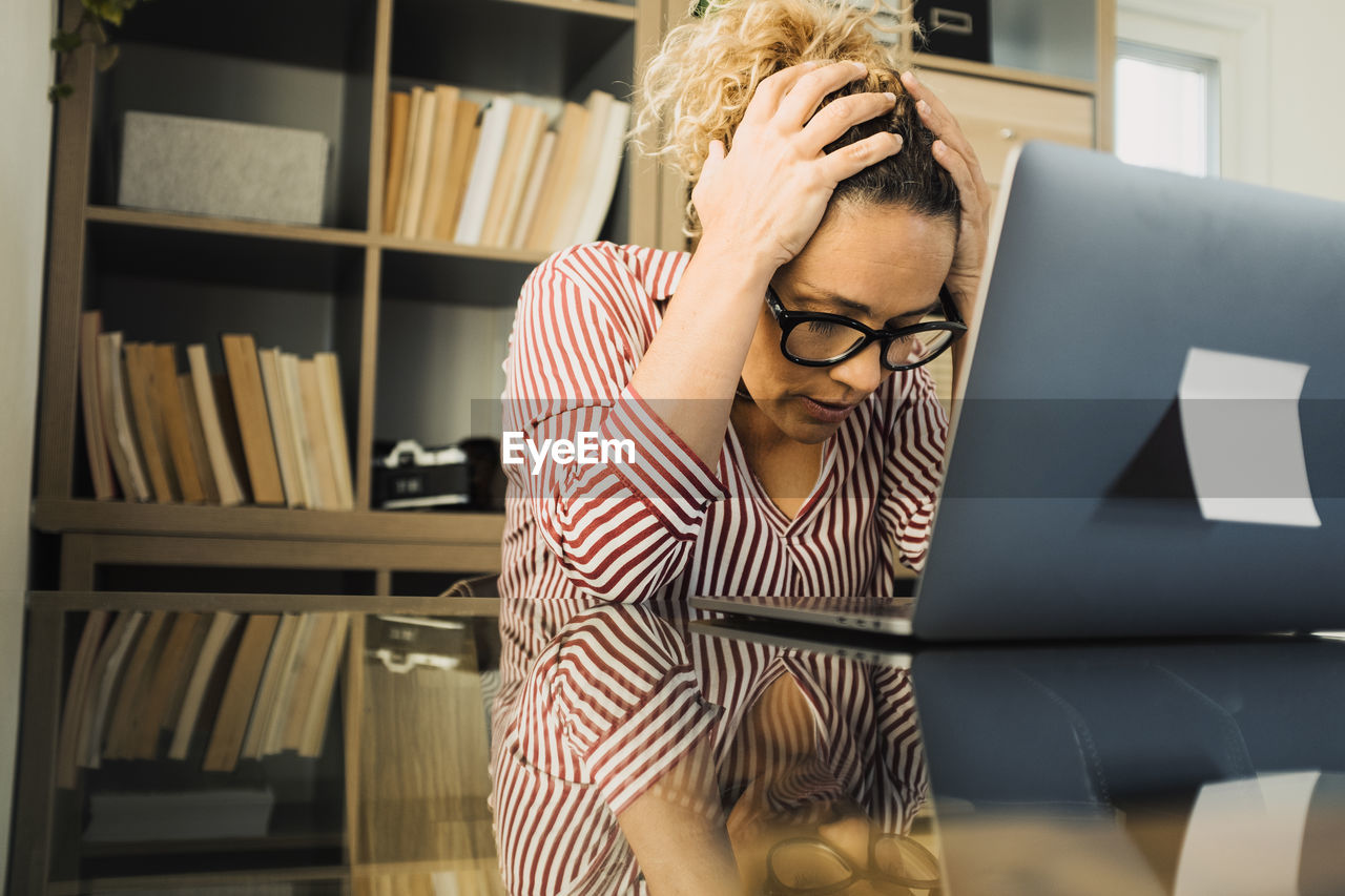 Frustrated woman sitting at office