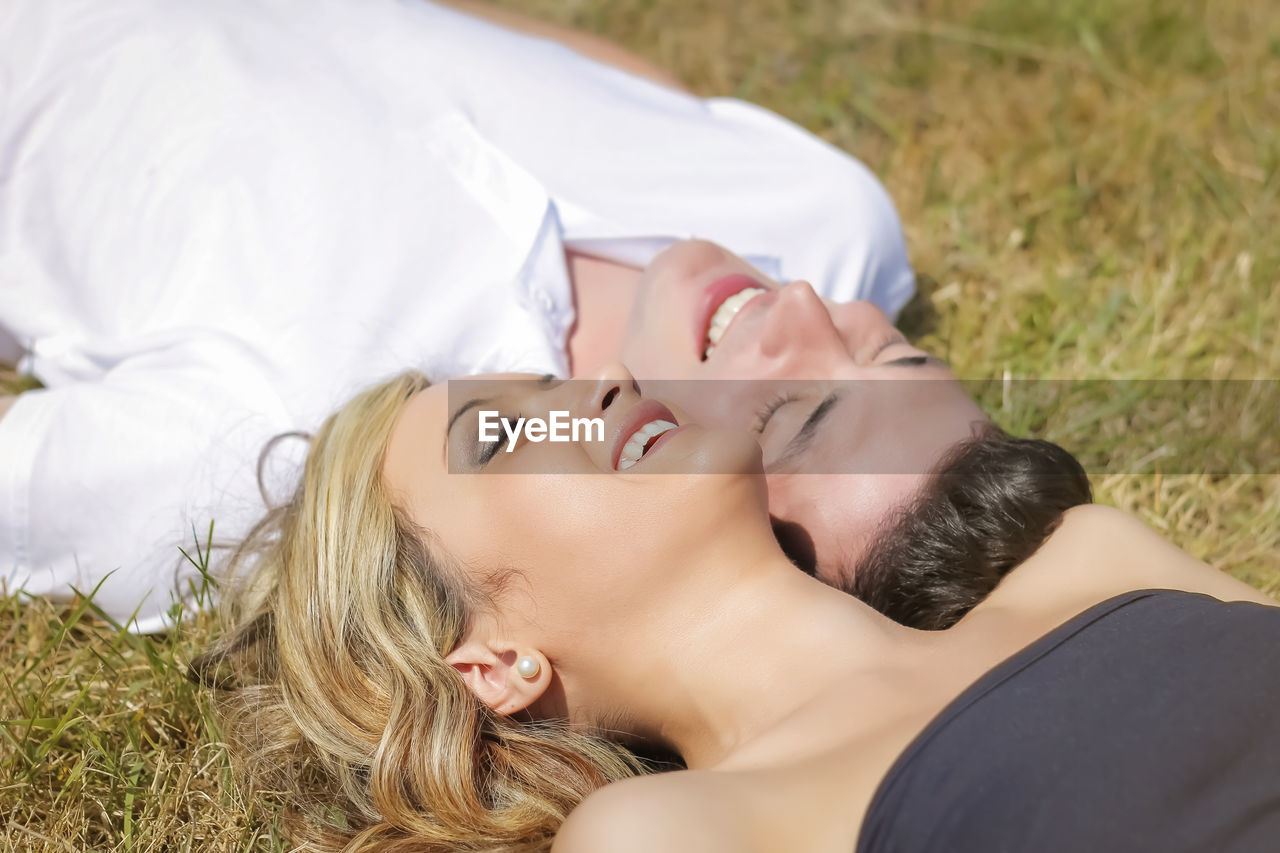 CLOSE-UP OF YOUNG WOMAN LYING DOWN