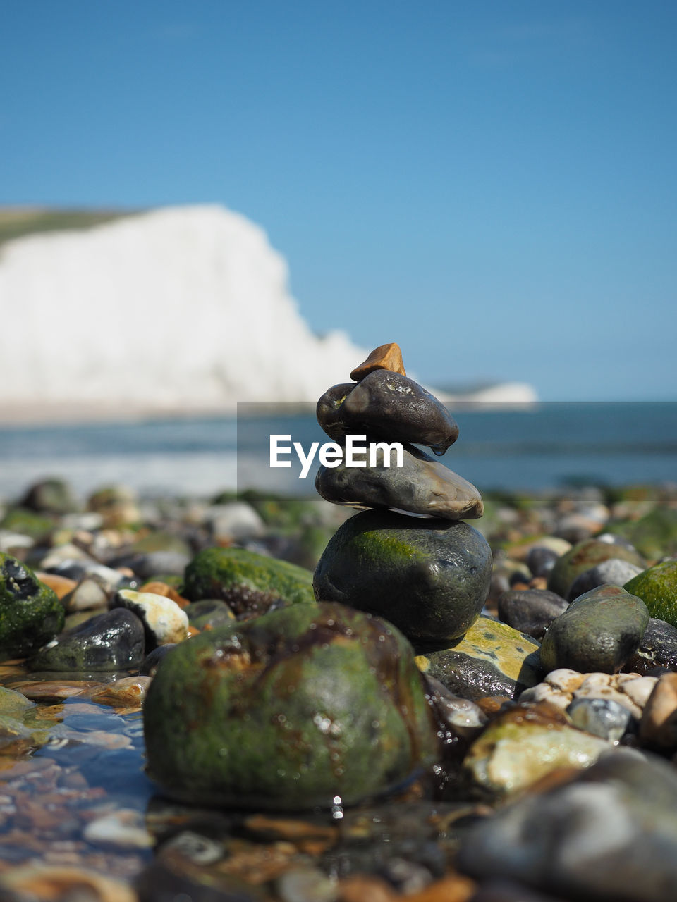 CLOSE-UP OF PEBBLES ON BEACH