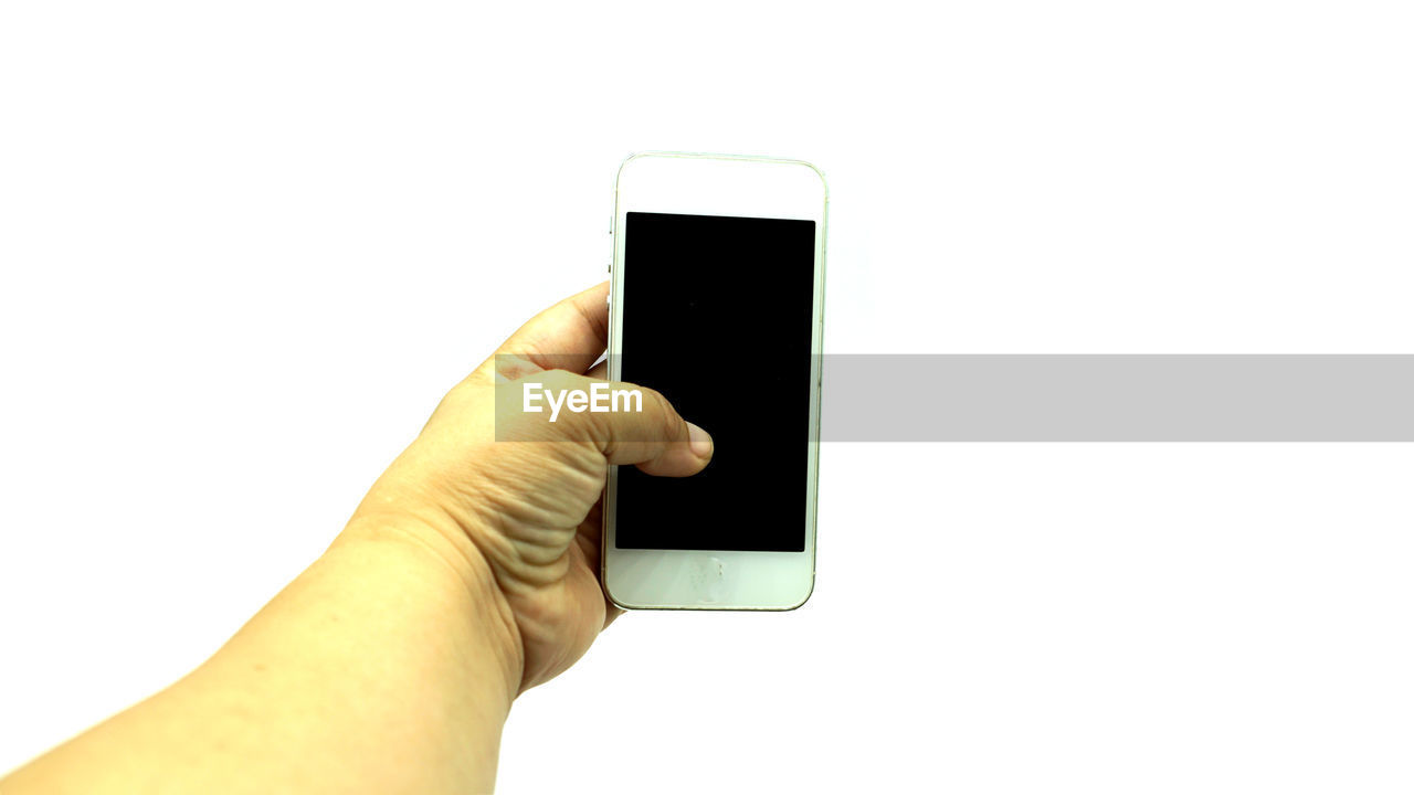 Hand holding mobile phone against white background