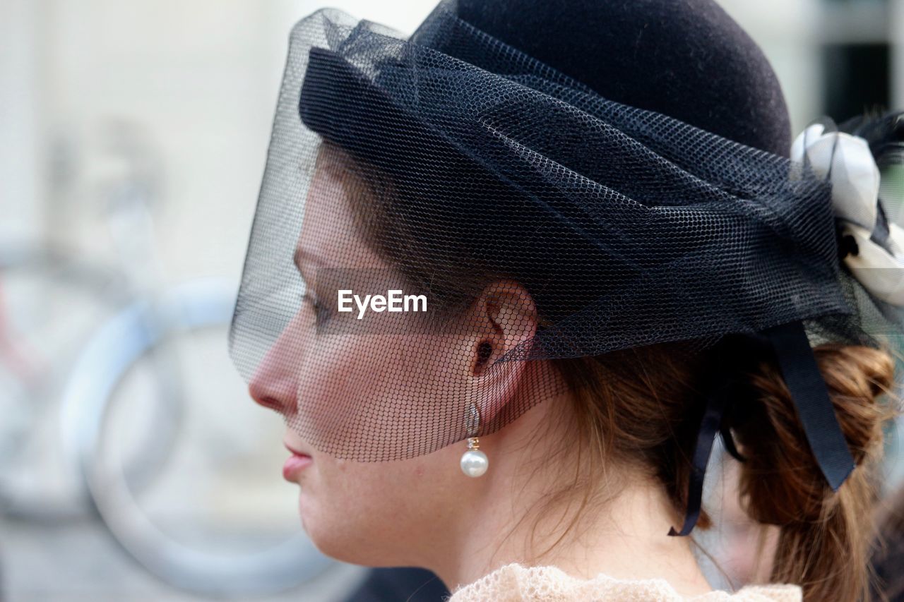 Close-up of beautiful woman wearing black hat