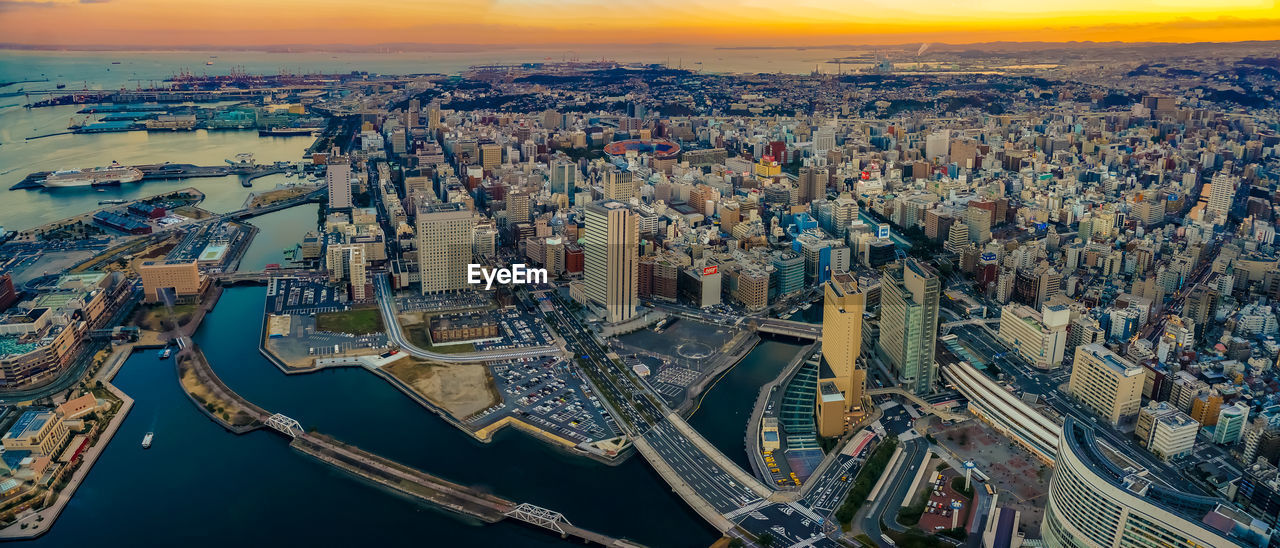 High angle view of city buildings against sky during sunset