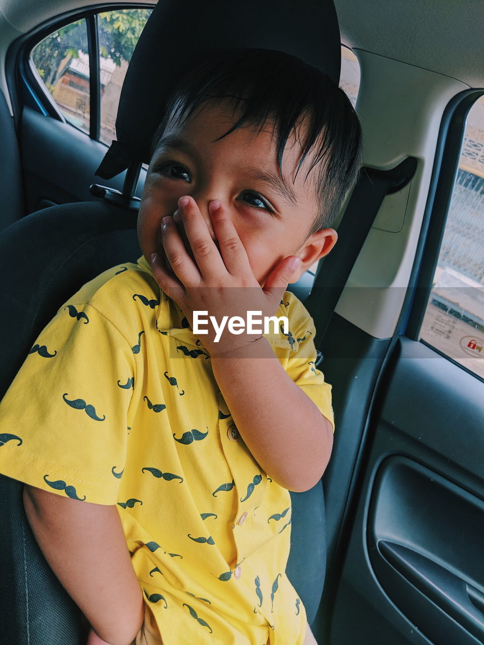 Smiling baby boy sitting in car