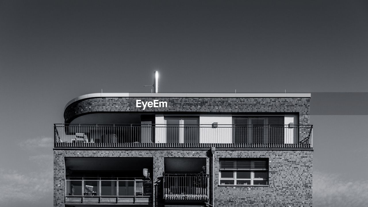 High section of apartment building against sky