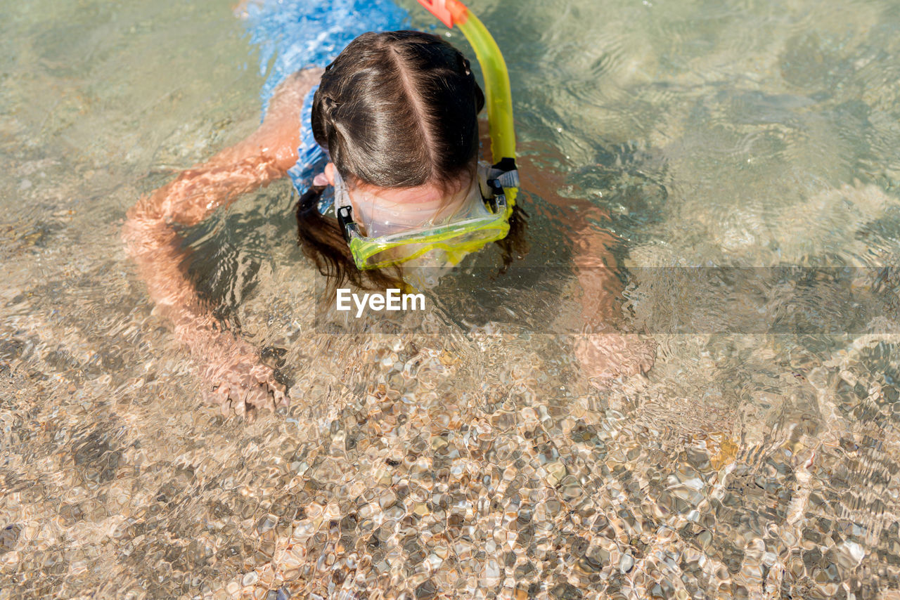 High angle view of girl snorkeling at shore