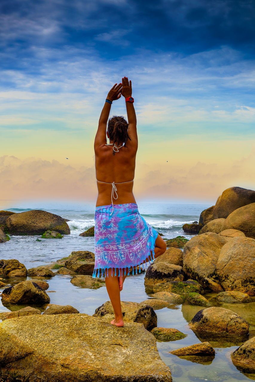 Rear view of woman standing on beach