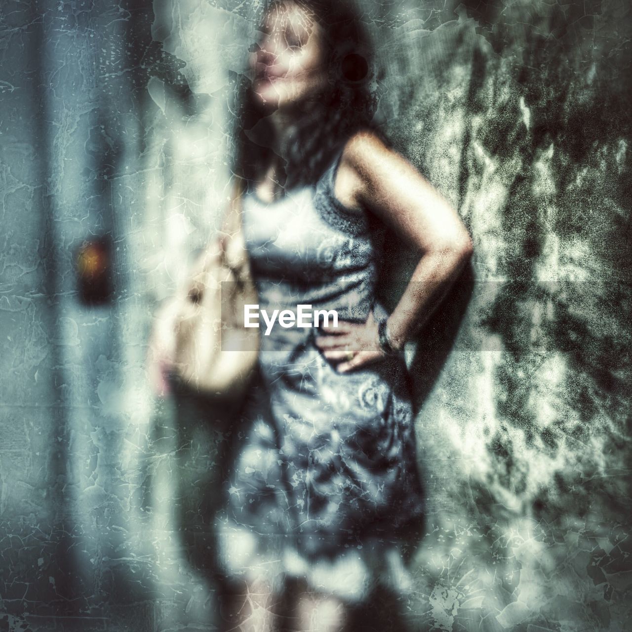 YOUNG WOMAN STANDING ON FLOOR IN MIRROR