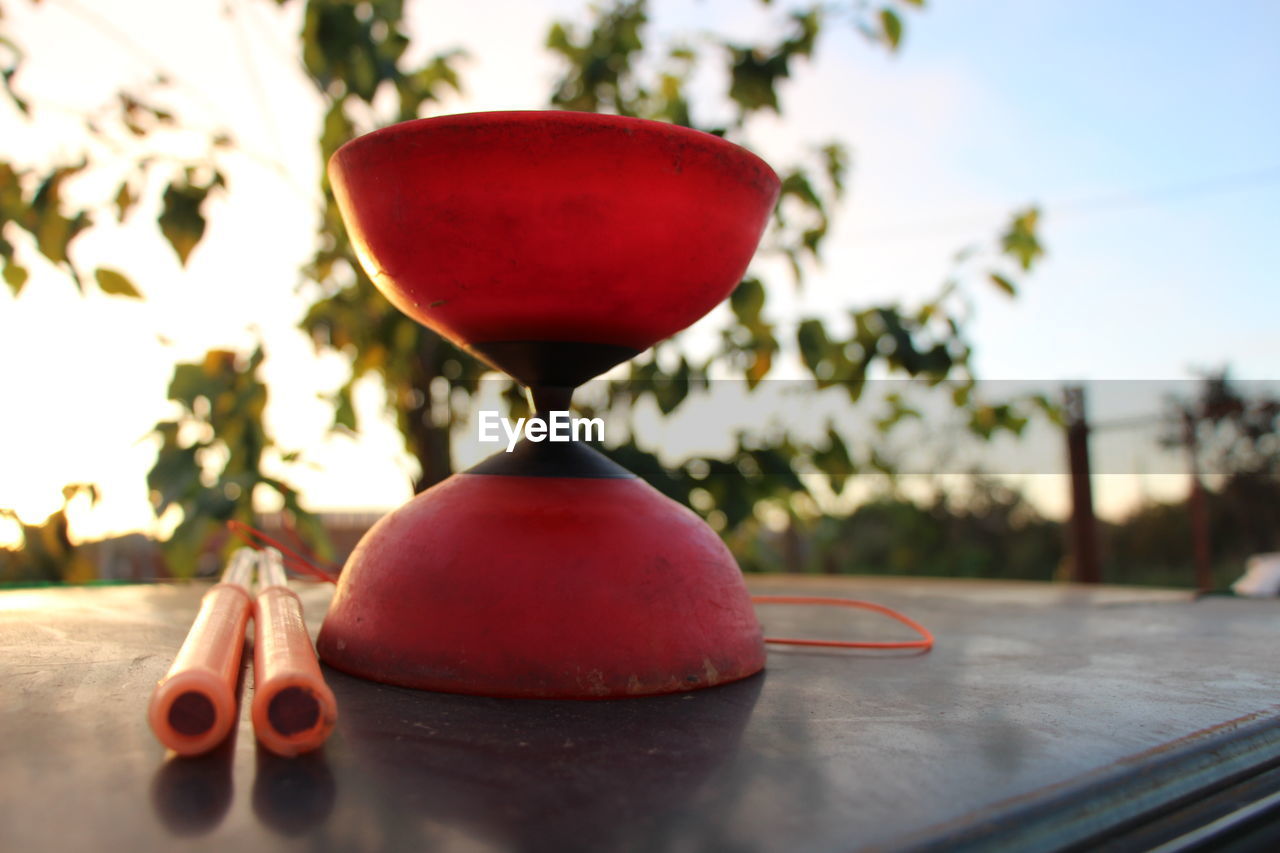 Close-up of diabolo toy on table during sunny day