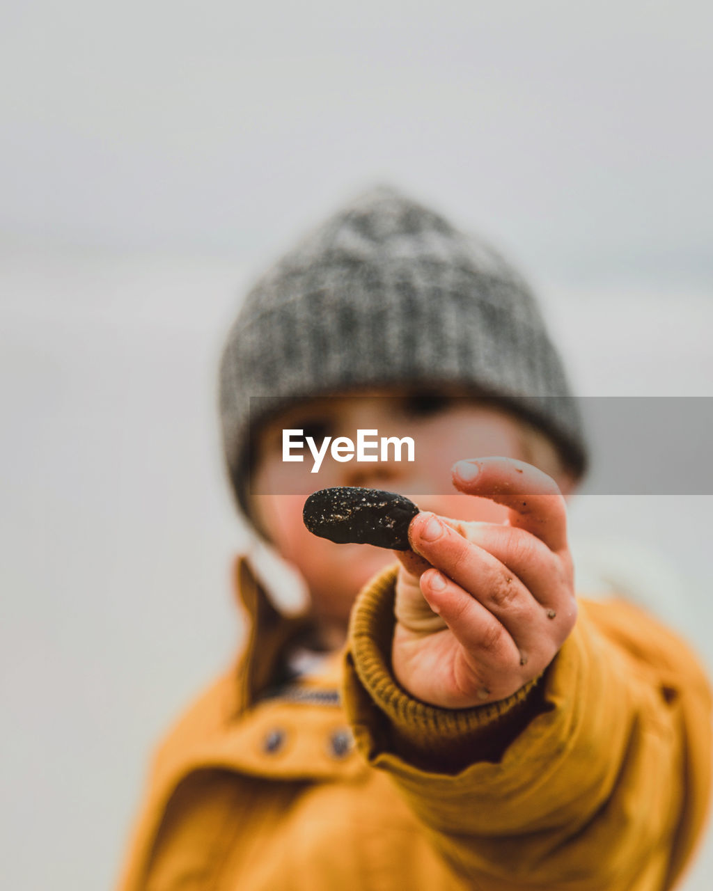 Close-up of boy holding stone