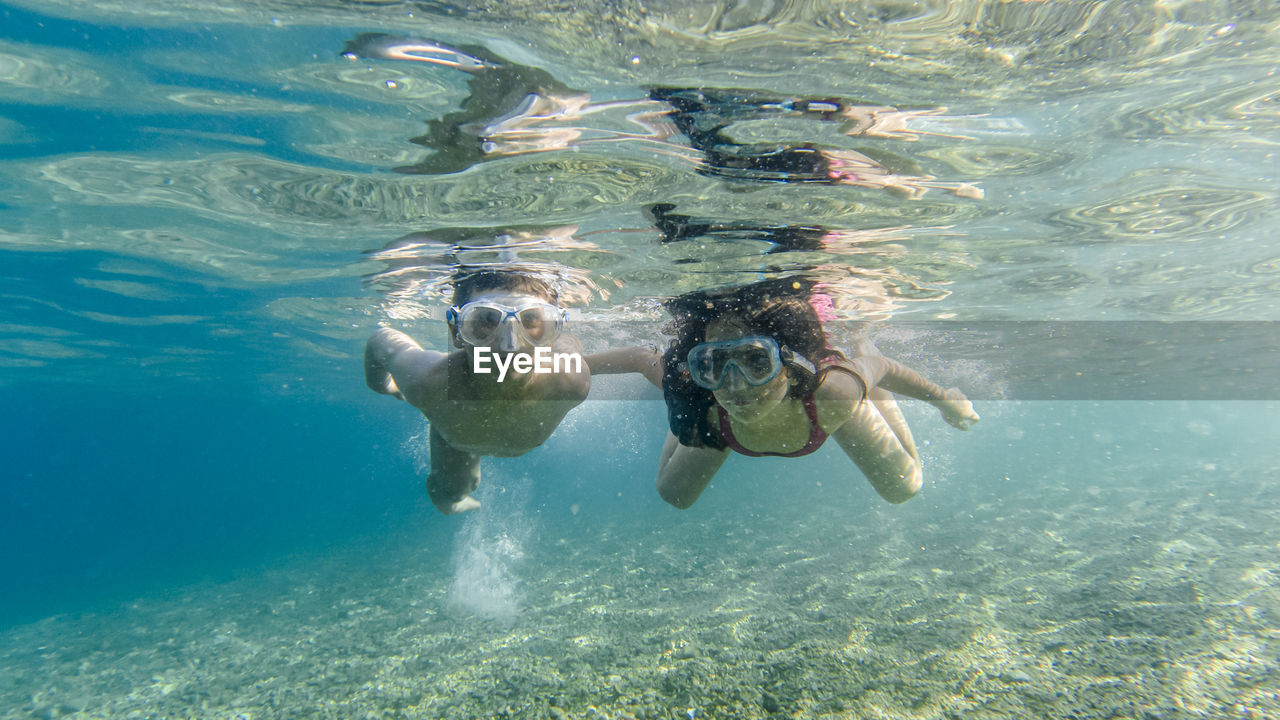Couple swimming undersea