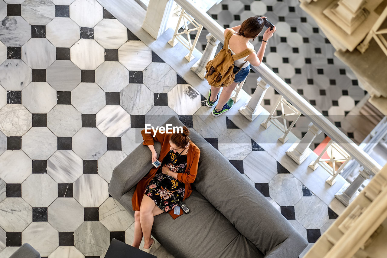 High angle view of women using mobile phone indoors