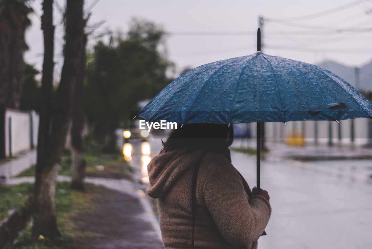 Woman with umbrella on street