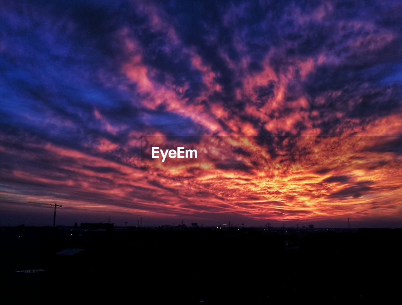 SILHOUETTE LANDSCAPE AGAINST DRAMATIC SKY