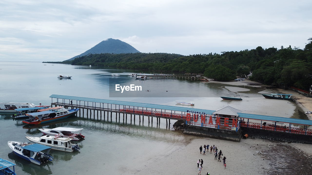 HIGH ANGLE VIEW OF PEOPLE AT BEACH AGAINST SKY