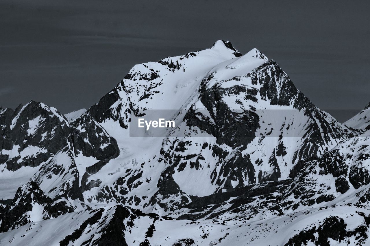 SNOW COVERED MOUNTAIN AGAINST SKY