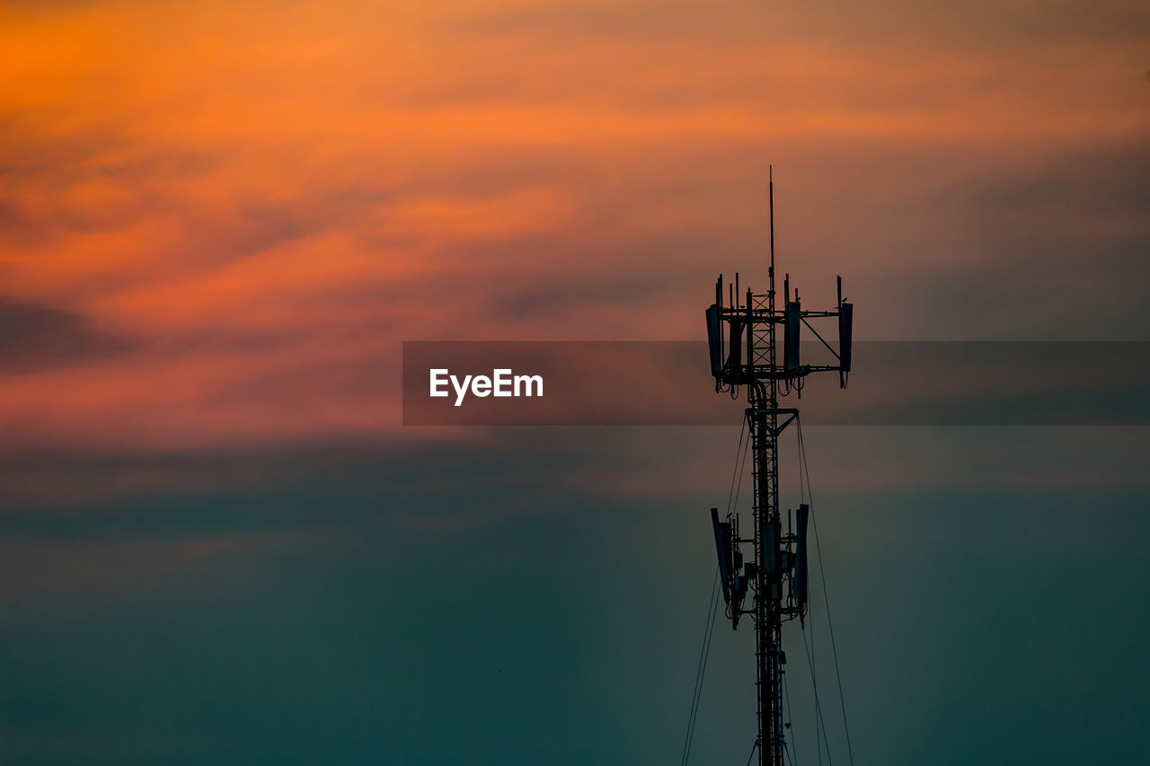 Silhouette crane against sky during sunset