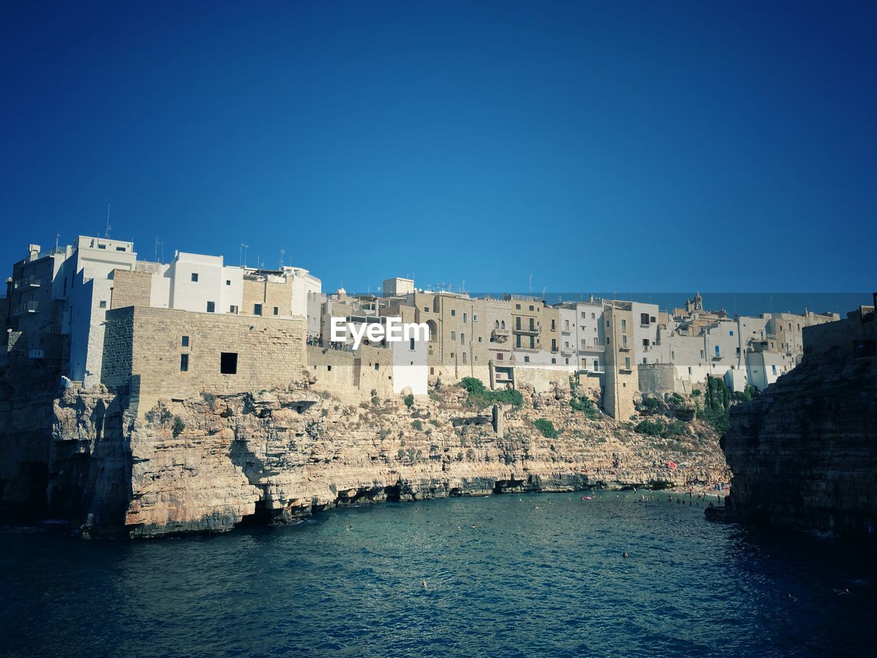 BUILDINGS AGAINST CLEAR BLUE SKY