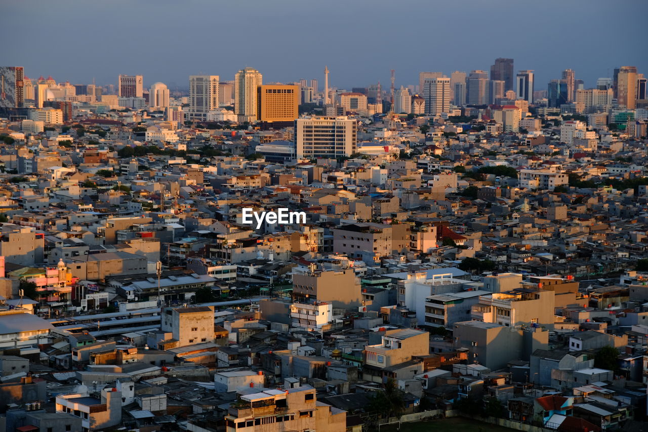 High angle view of buildings in city against clear sky