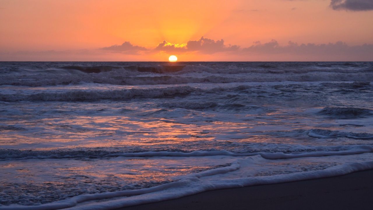 SCENIC VIEW OF BEACH DURING SUNSET