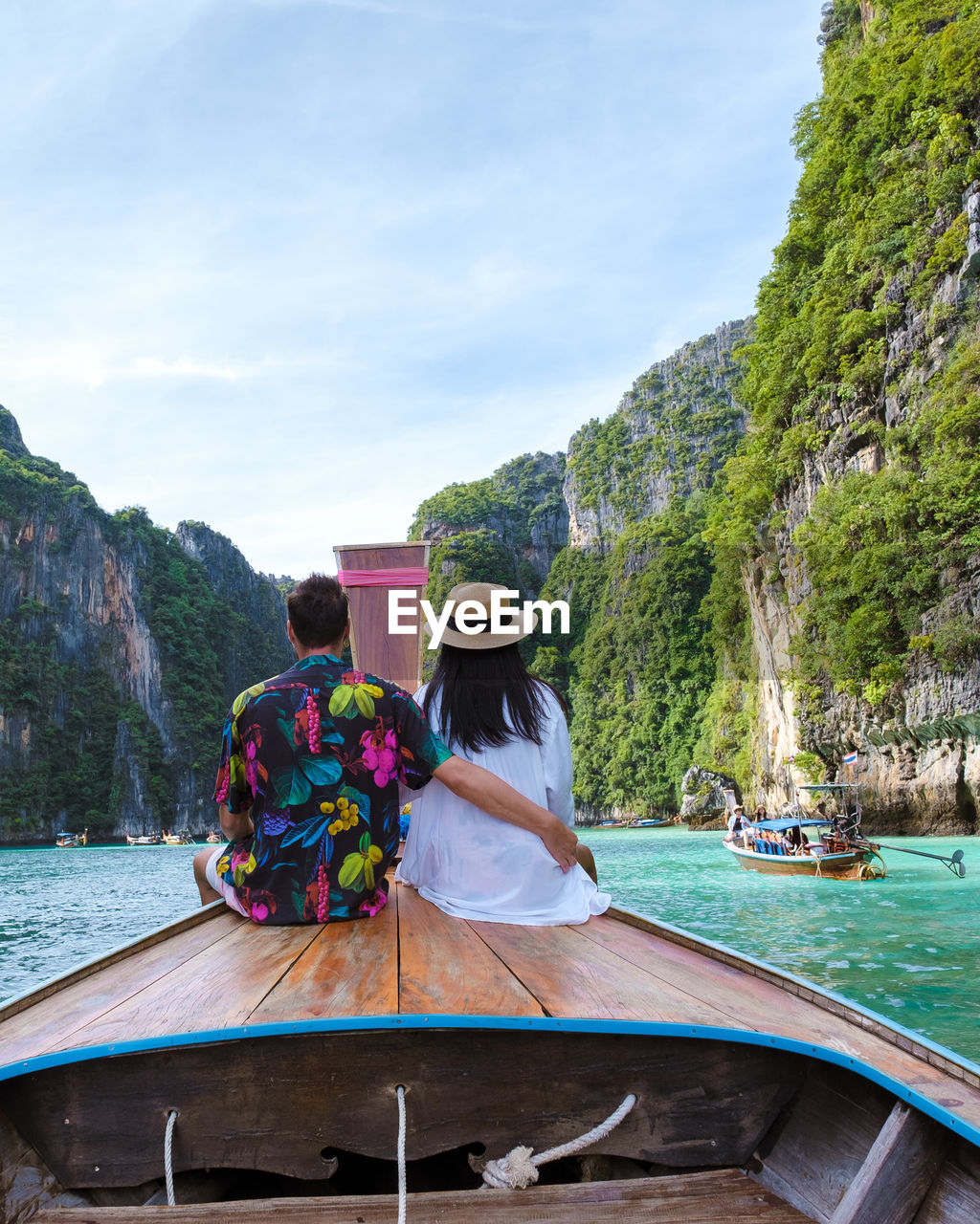 rear view of woman standing by river against mountain