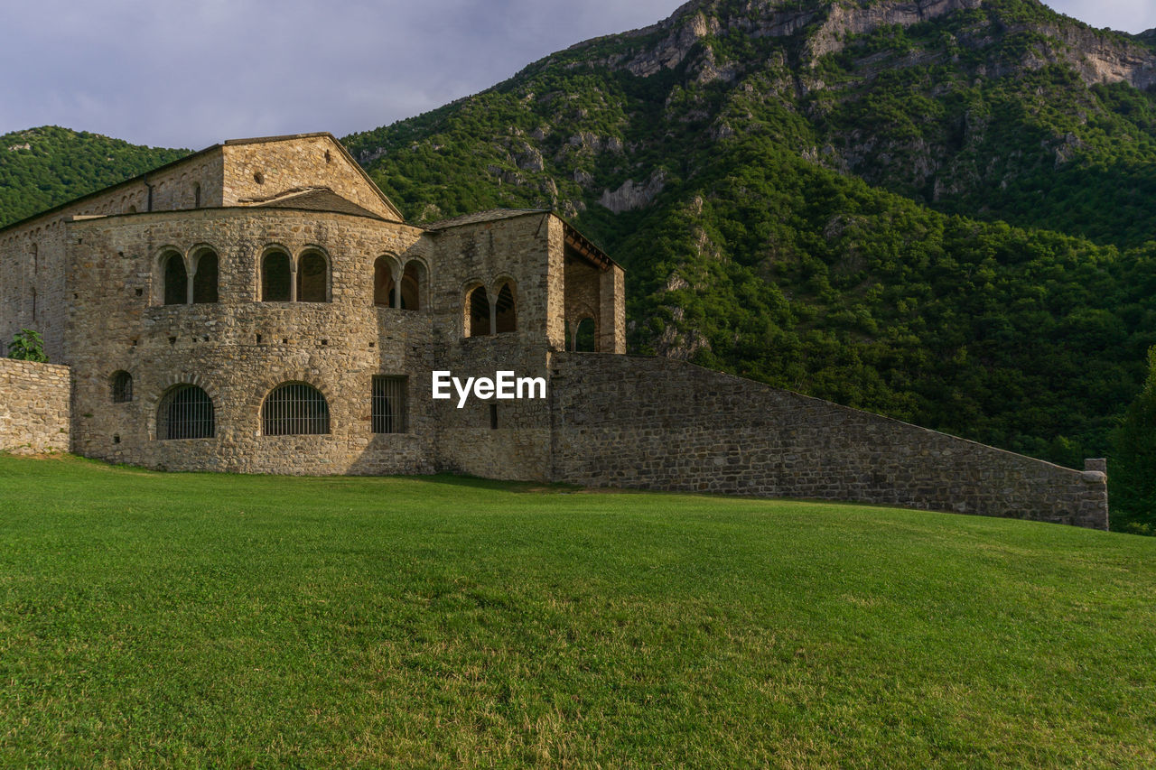 Abbey of san pietro al monte in civate, a religious complex surrounded by mountain in  italy