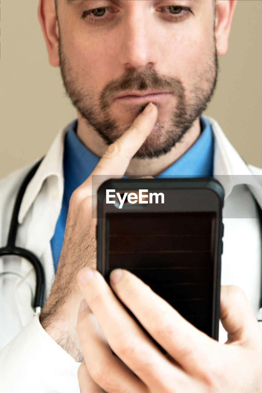 Close-up of male doctor using mobile phone