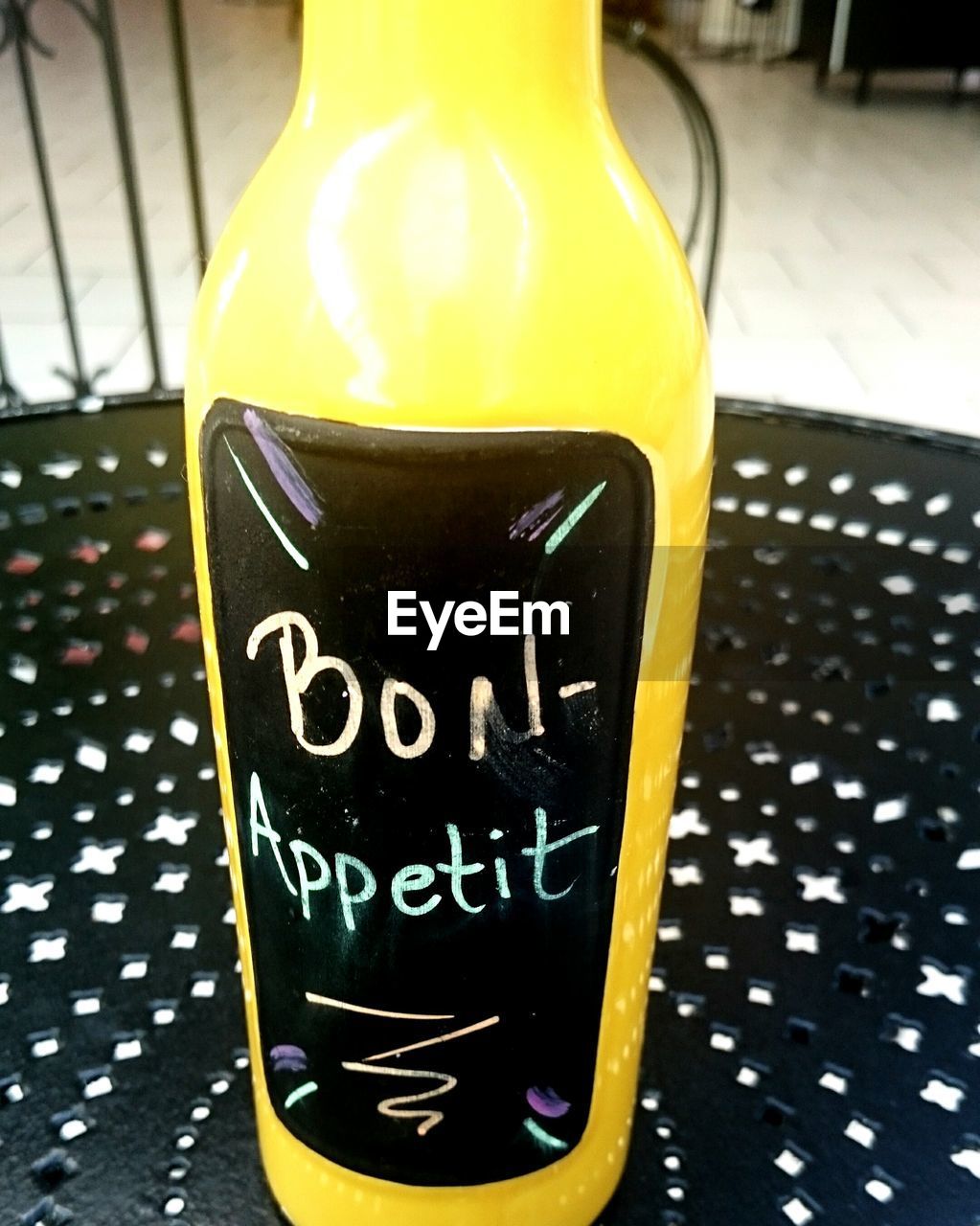Close-up of yellow bottle with text on table