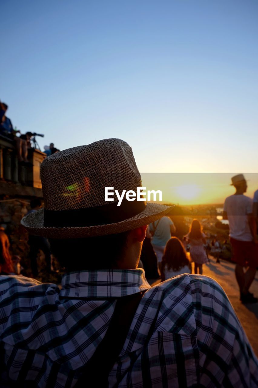 Rear view of man wearing hat during sunset